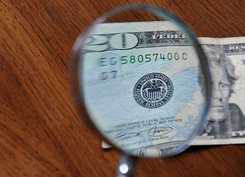 Hand lens on paper money