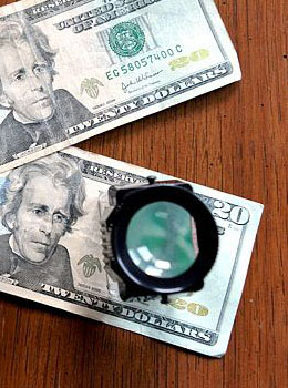 Magnifying glass on paper money