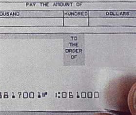 Scotch tape lifts ink off a check