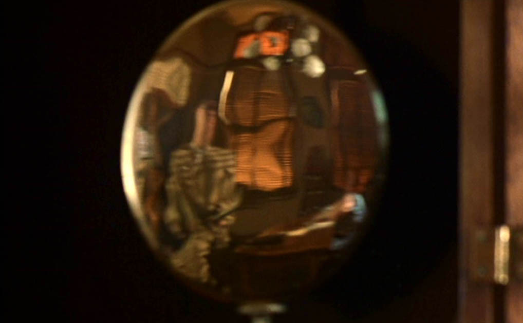 Frank Abagnale reflected in the pendulum of a longcase clock