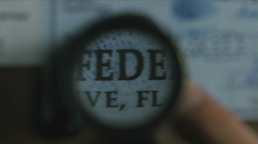 Magnifying glass on forged check