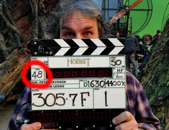 Director Peter Jackson with clapperboard on the movie set